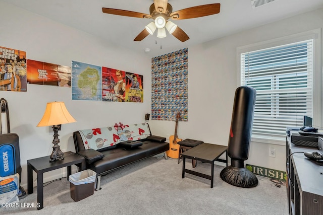 carpeted living room with ceiling fan