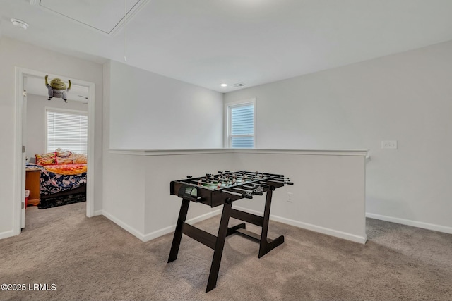 recreation room featuring light carpet