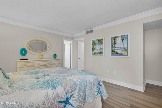 bedroom featuring crown molding, a textured ceiling, and hardwood / wood-style flooring