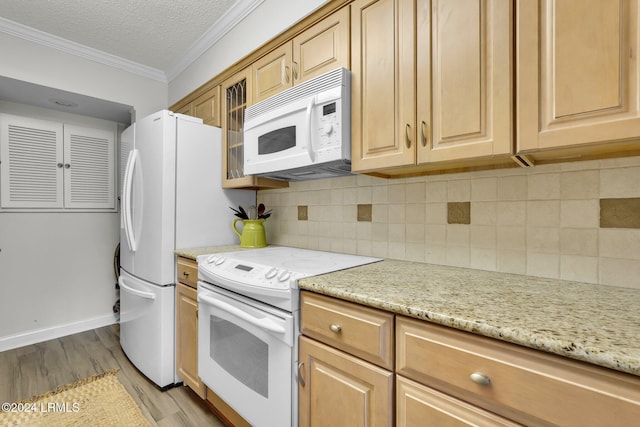 kitchen featuring backsplash, ornamental molding, white appliances, light stone countertops, and light wood-type flooring