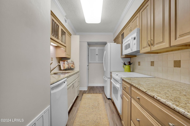 kitchen featuring sink, white appliances, ornamental molding, a textured ceiling, and decorative backsplash