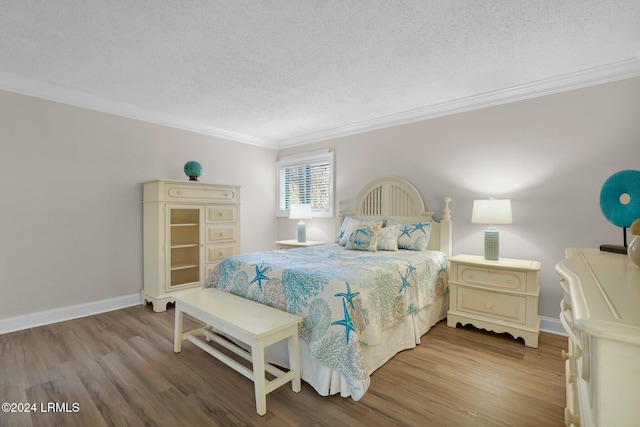 bedroom featuring crown molding, a textured ceiling, and hardwood / wood-style flooring