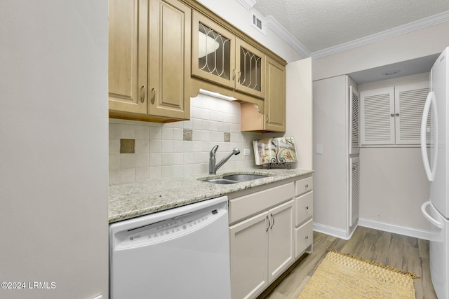 kitchen featuring sink, white appliances, backsplash, ornamental molding, and light brown cabinetry