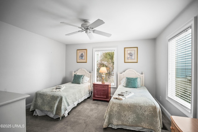 bedroom featuring a ceiling fan, dark colored carpet, and baseboards