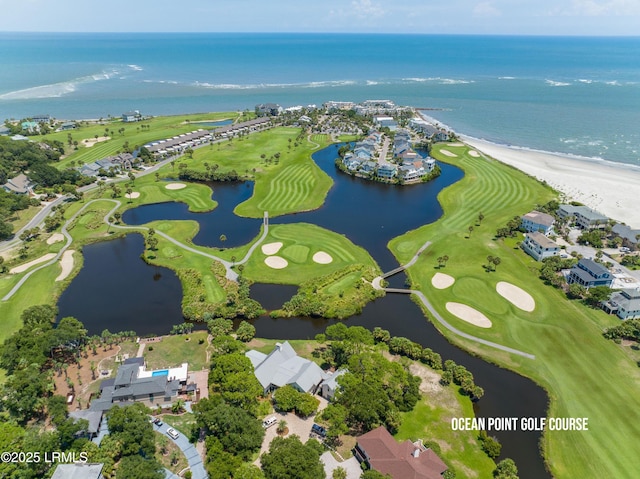 aerial view with golf course view and a water view