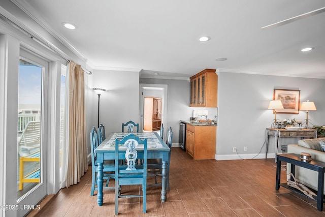 dining area featuring wood finish floors, crown molding, baseboards, and recessed lighting