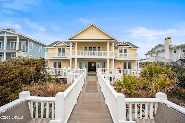 back of house featuring a balcony and a residential view