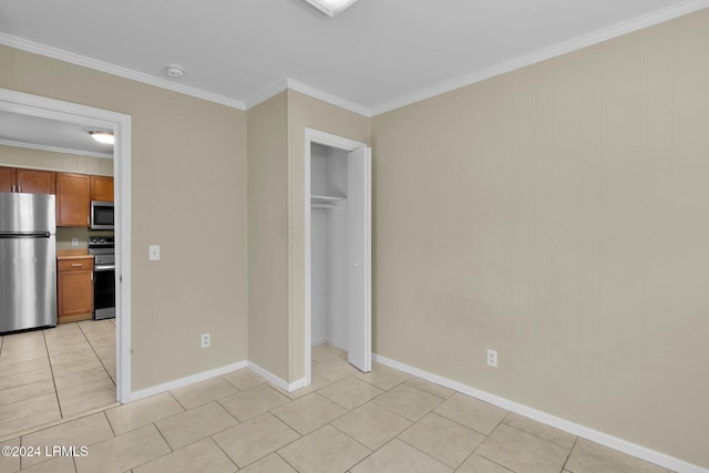 unfurnished bedroom featuring crown molding, light tile patterned floors, stainless steel fridge, and a closet