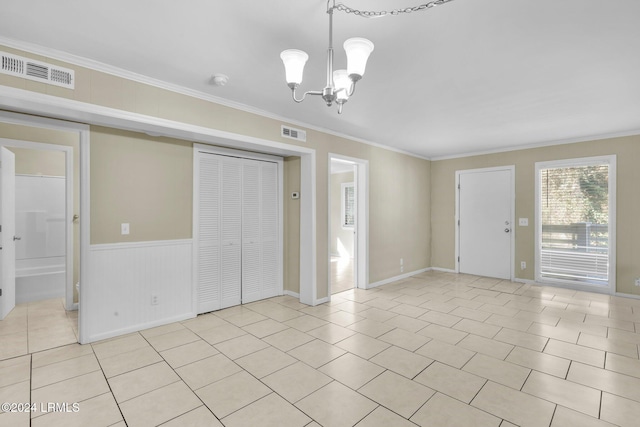 interior space featuring crown molding, light tile patterned floors, and an inviting chandelier