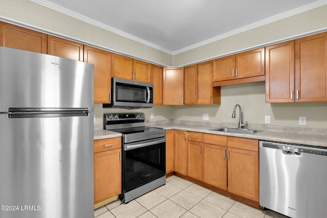 kitchen with crown molding, stainless steel appliances, sink, and light tile patterned floors