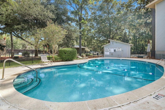 view of pool featuring an outbuilding