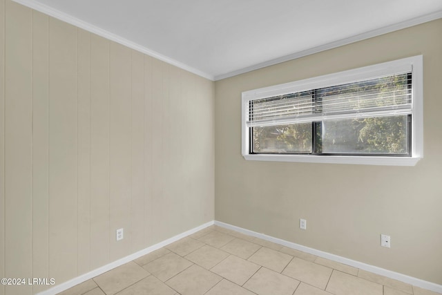 unfurnished room featuring plenty of natural light, ornamental molding, and light tile patterned flooring