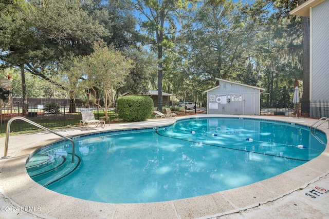 view of pool featuring an outbuilding