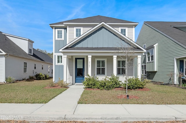 2727 Switchgrass Dr, Beaufort, SC 29902 - view of front of property featuring board and batten siding, a porch, and a front lawn