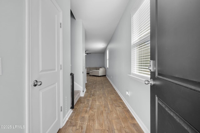 hallway with baseboards and light wood-type flooring