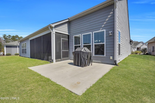 back of property with a patio area, a yard, and a sunroom