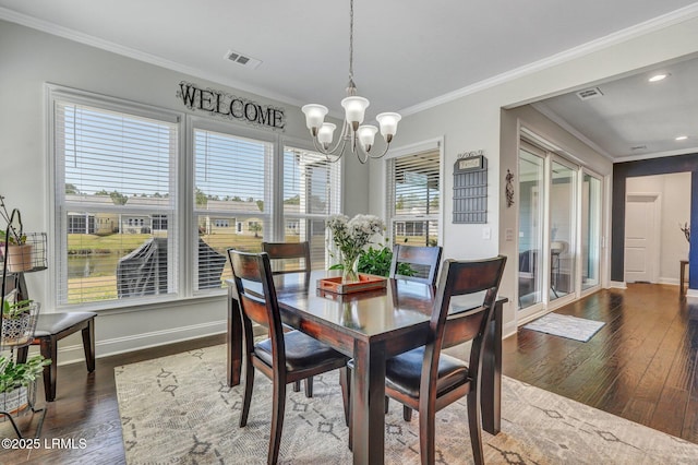 dining space with visible vents, crown molding, baseboards, a notable chandelier, and dark wood-style flooring