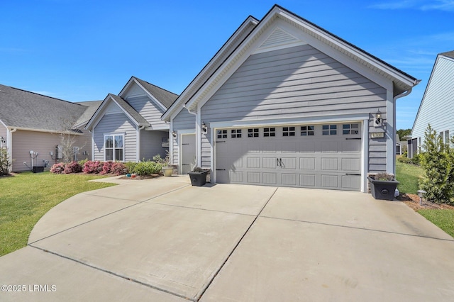 ranch-style home with a front lawn, concrete driveway, and a garage