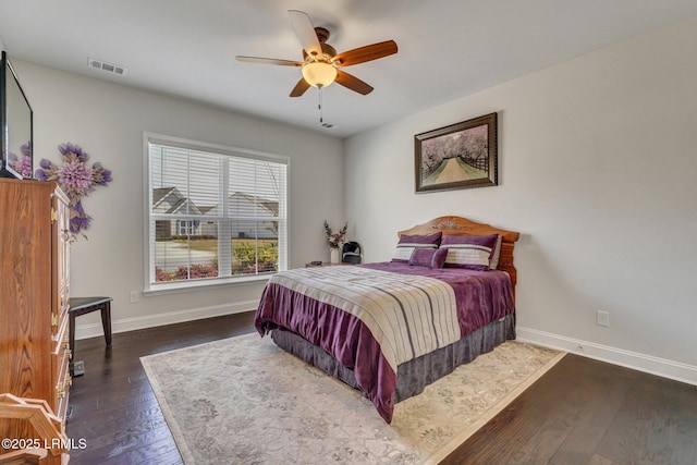 bedroom with baseboards, visible vents, wood-type flooring, and ceiling fan