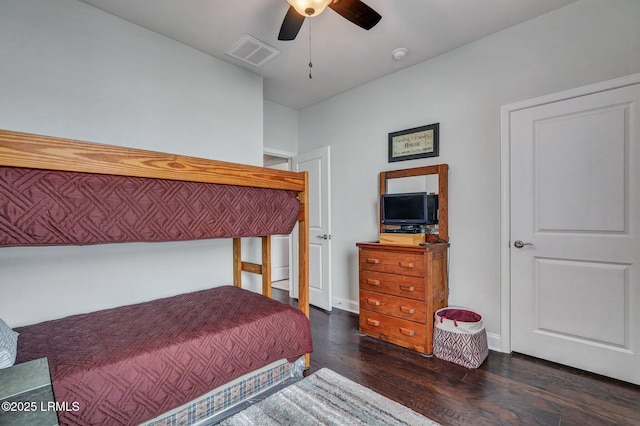 bedroom with ceiling fan, wood finished floors, visible vents, and baseboards