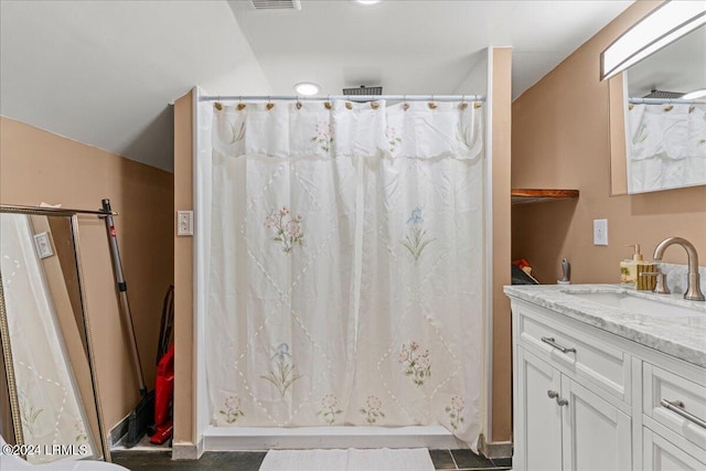 bathroom featuring vanity, lofted ceiling, and a shower with shower curtain