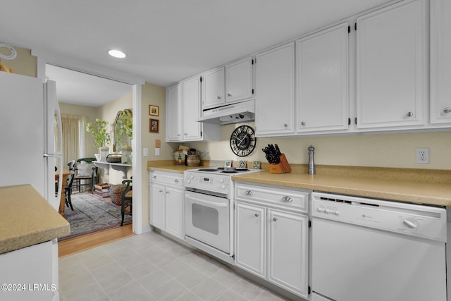 kitchen featuring white cabinetry and white appliances