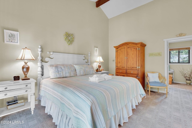 carpeted bedroom with beam ceiling and high vaulted ceiling