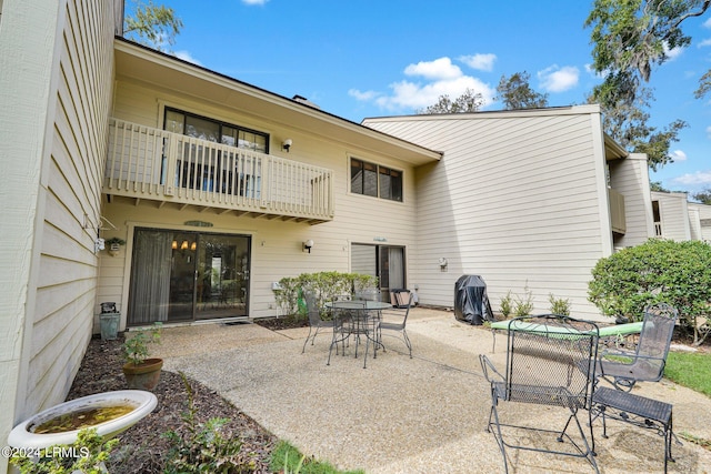 back of property with a balcony and a patio area