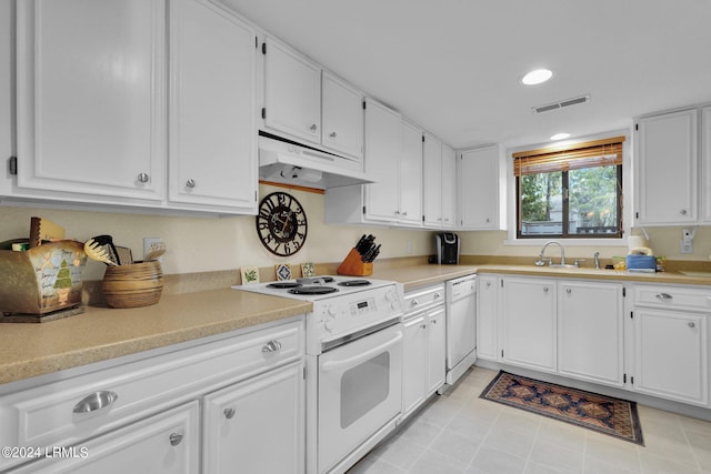 kitchen with white cabinetry, white appliances, and sink