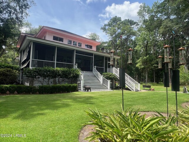 15 Jacks Dr, Daufuskie Island, SC 29915 - view of front of house with a front yard and a sunroom