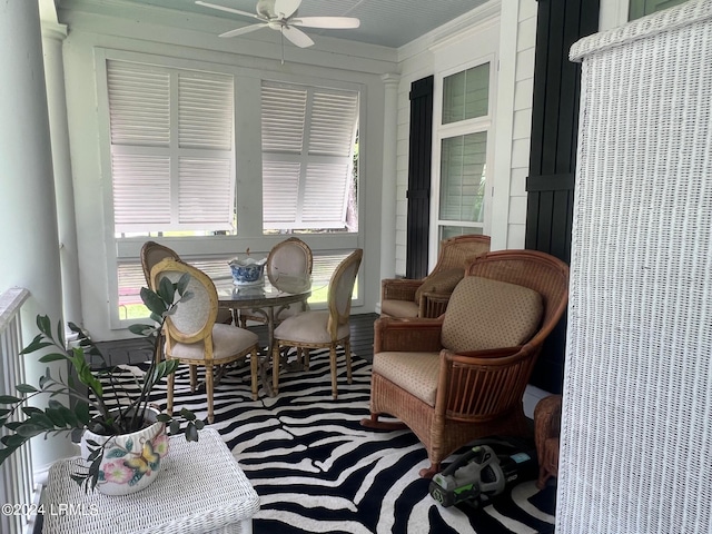 sunroom featuring ceiling fan