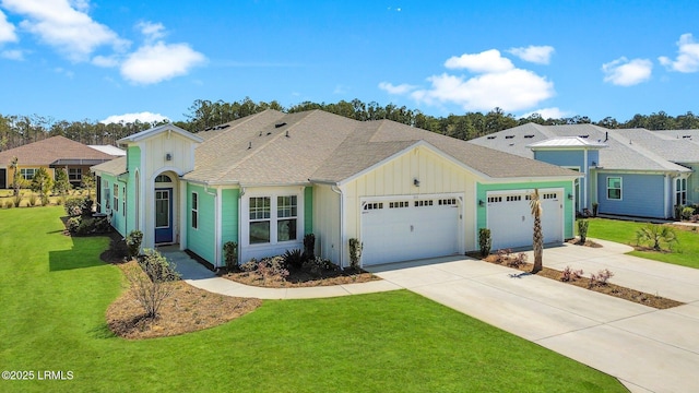 single story home with a front yard, an attached garage, board and batten siding, and concrete driveway