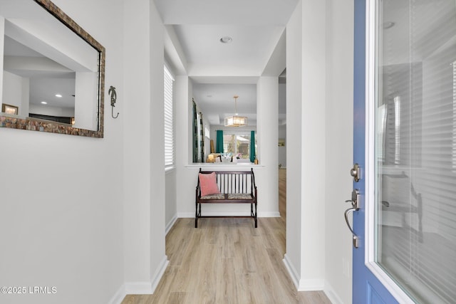 foyer featuring baseboards and light wood finished floors