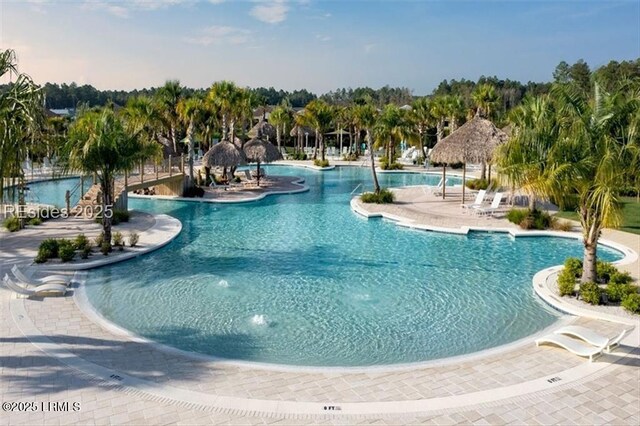 community pool featuring fence and a patio