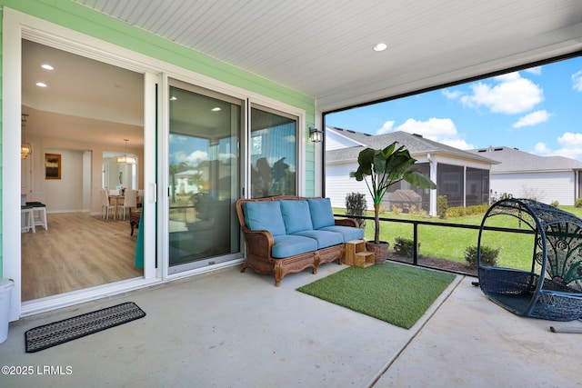 sunroom with an inviting chandelier and outdoor lounge area