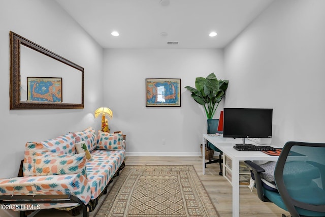 home office with baseboards, visible vents, recessed lighting, and light wood-type flooring