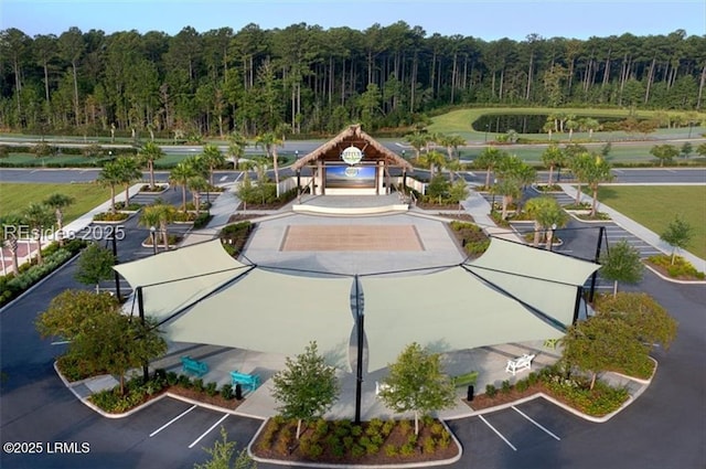 view of home's community featuring uncovered parking, a gazebo, and a forest view