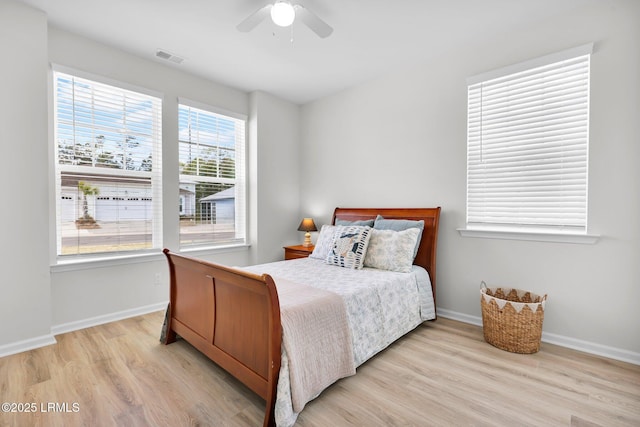 bedroom with a ceiling fan, baseboards, light wood-style floors, and visible vents