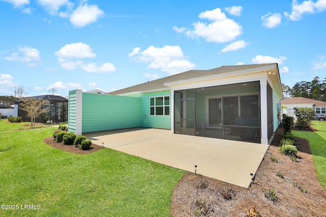 back of property featuring a lawn, a sunroom, and roof with shingles