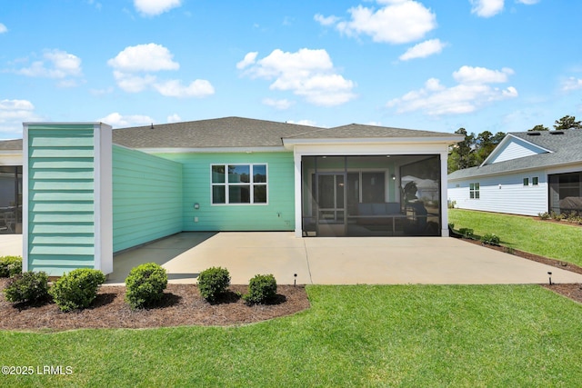 back of house with a sunroom, a shingled roof, a yard, and a patio area