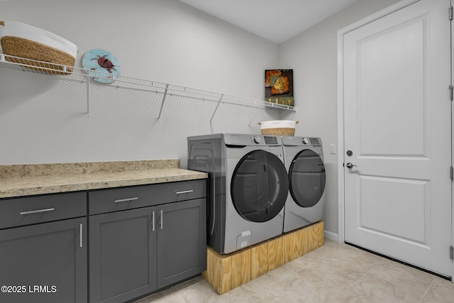 washroom with light tile patterned floors and washing machine and dryer