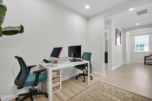 home office with baseboards, light wood-style flooring, visible vents, and recessed lighting