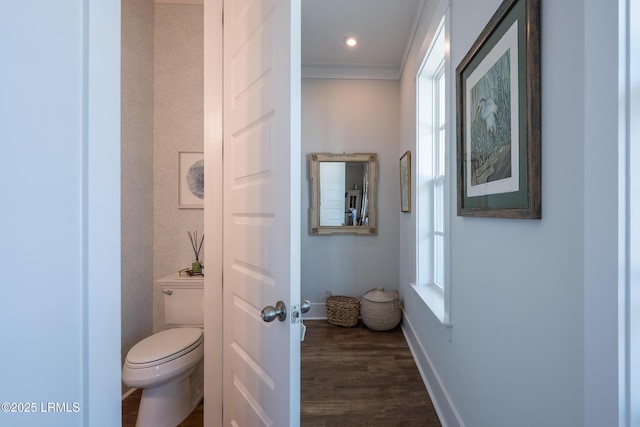 bathroom featuring ornamental molding, toilet, baseboards, and wood finished floors