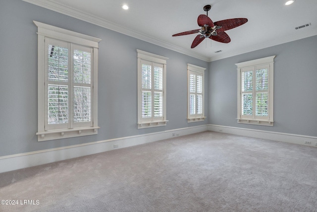 carpeted spare room featuring crown molding and ceiling fan