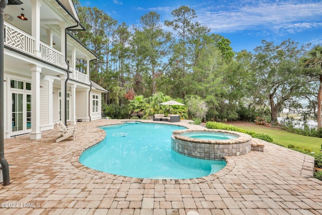 view of swimming pool with an in ground hot tub and a patio