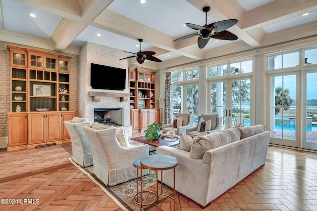 living room featuring beam ceiling, coffered ceiling, a large fireplace, french doors, and light parquet flooring