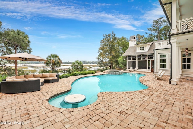 view of swimming pool featuring an outdoor hangout area, a sunroom, a patio, and an in ground hot tub