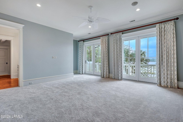 spare room featuring ornamental molding and carpet flooring