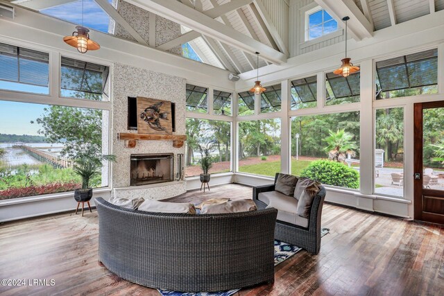 sunroom with a fireplace and lofted ceiling with beams