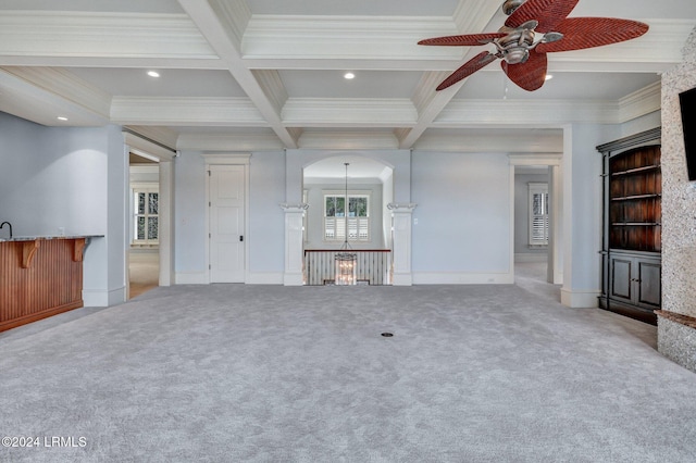 unfurnished living room with coffered ceiling, beam ceiling, ornamental molding, and carpet